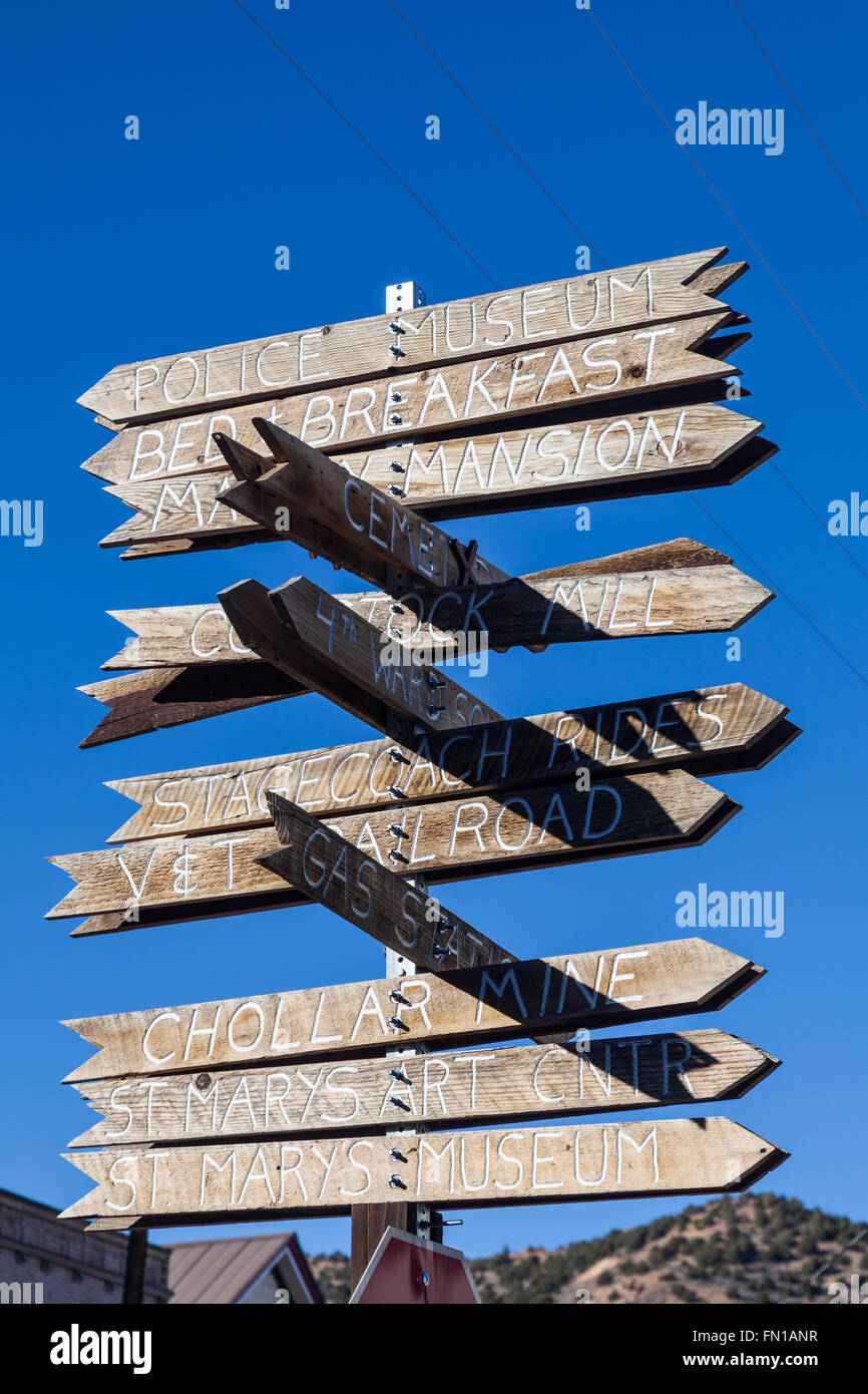 Directional tourist signs mounted on a pole in Virginia City, Nevada Stock Photo