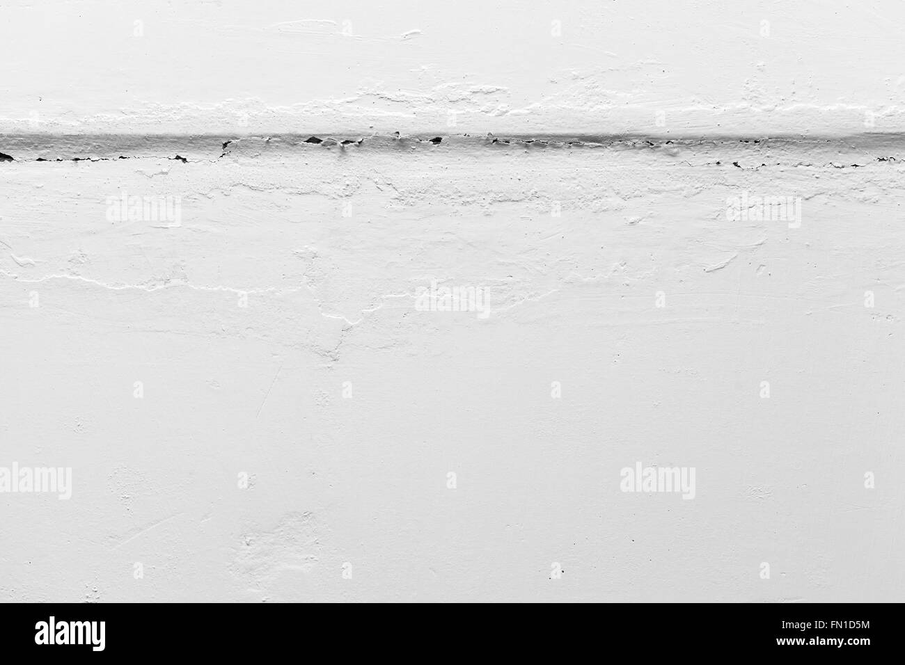 Horizontal crack in white painted wall, closeup photo texture Stock Photo