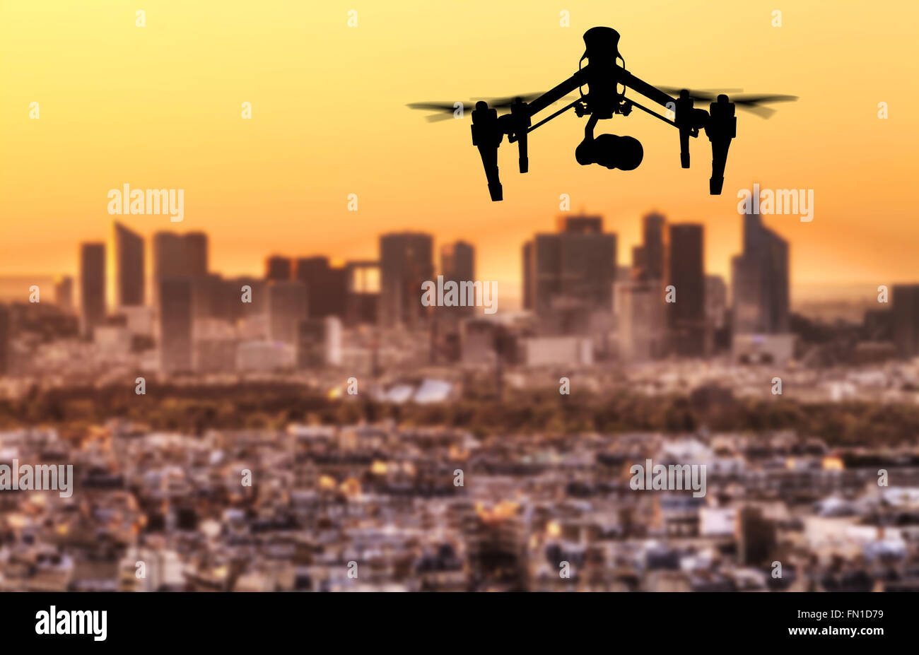 Drone silhouette flying above Paris city panorama Stock Photo