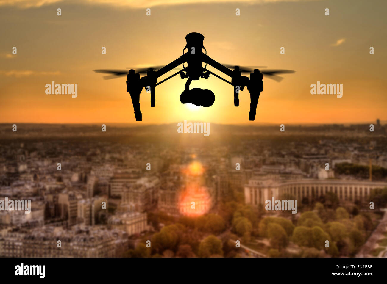 Drone silhouette flying above Paris city panorama Stock Photo