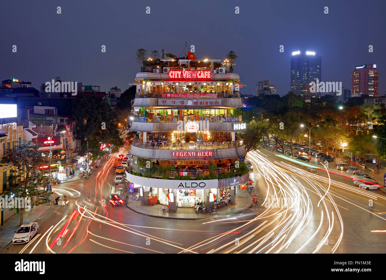 Light streaks of vehicles around shops and restaurants, Old Quarter, Hanoi, Vietnam Stock Photo