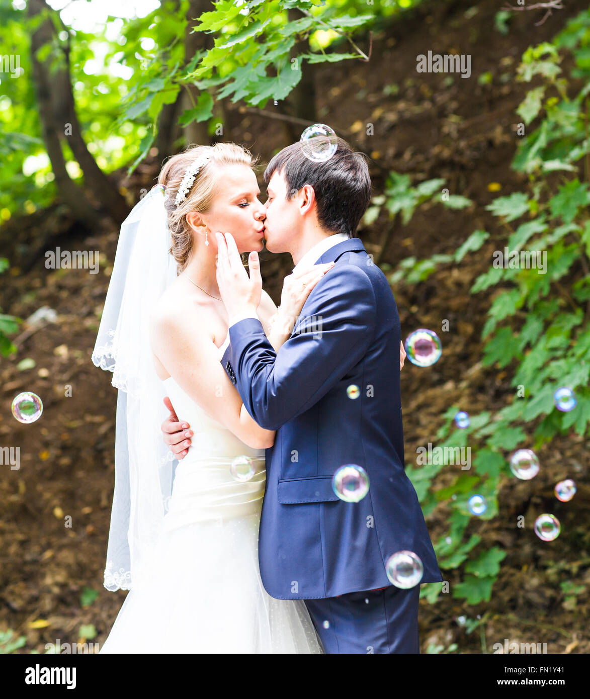 Wedding, Beautiful Romantic Bride and Groom Kissing Stock Photo - Alamy