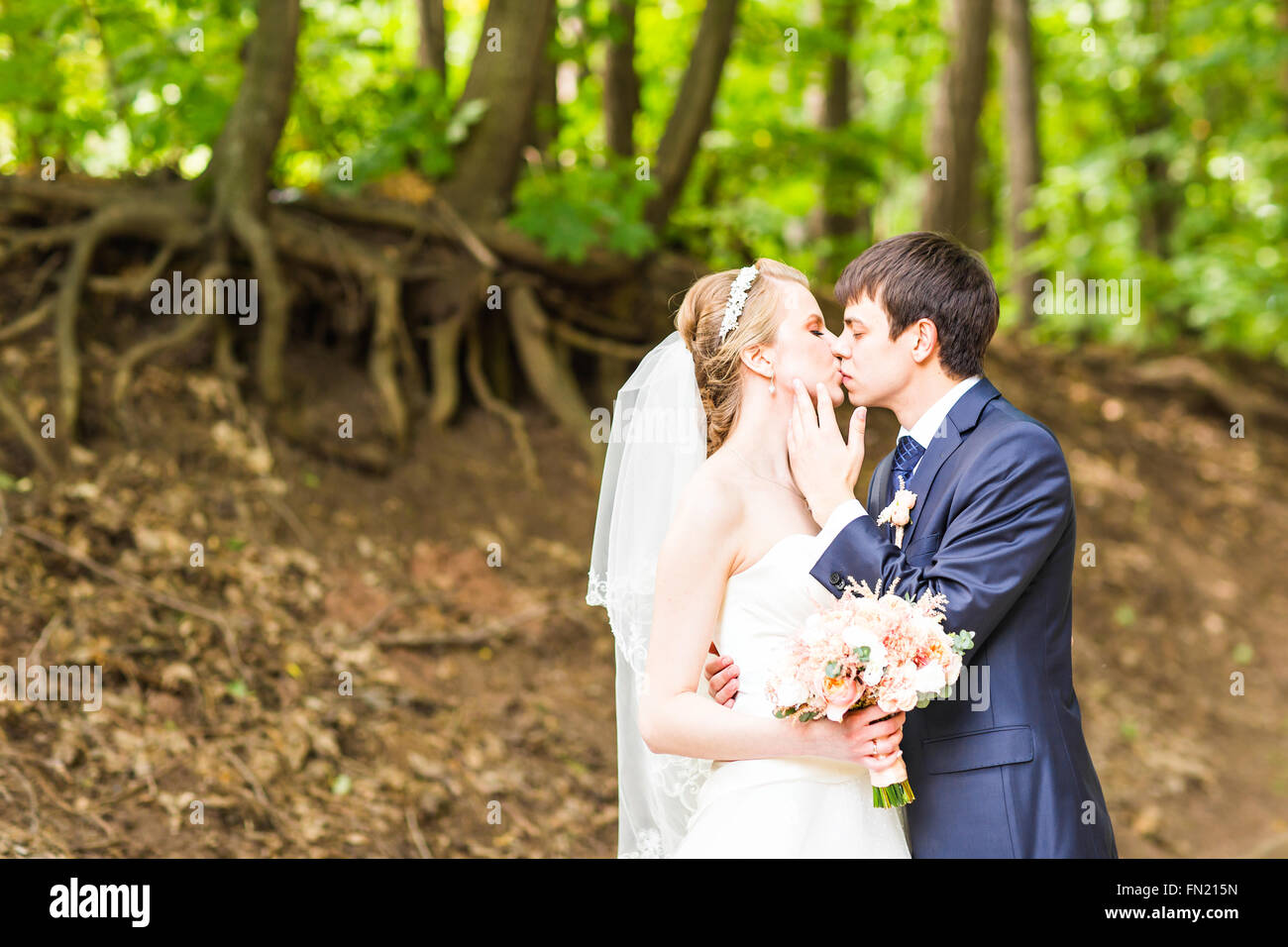 Wedding, Beautiful Romantic Bride and Groom Kissing Stock Photo - Alamy