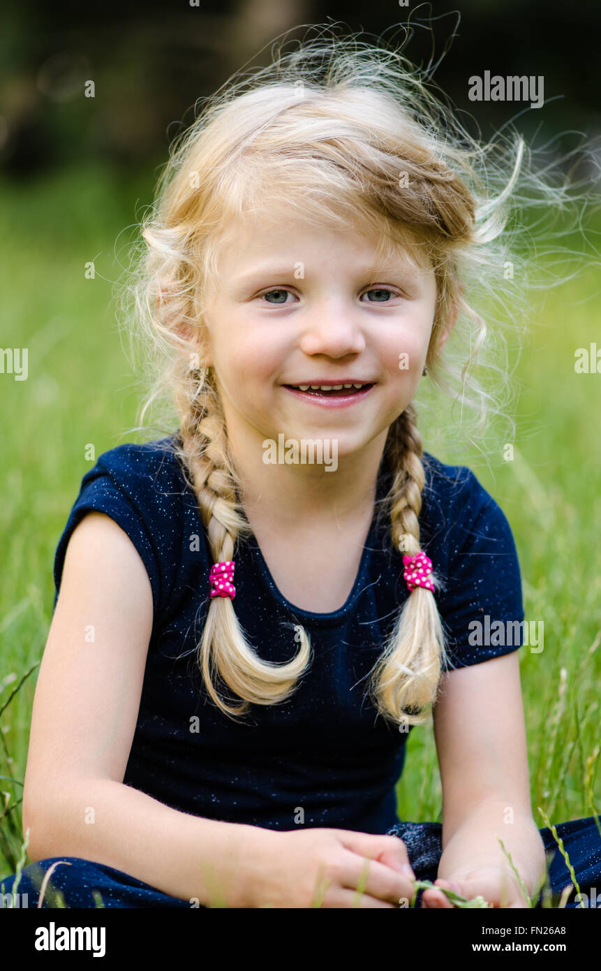 portrait of happy blond girl with long raided hair Stock Photo