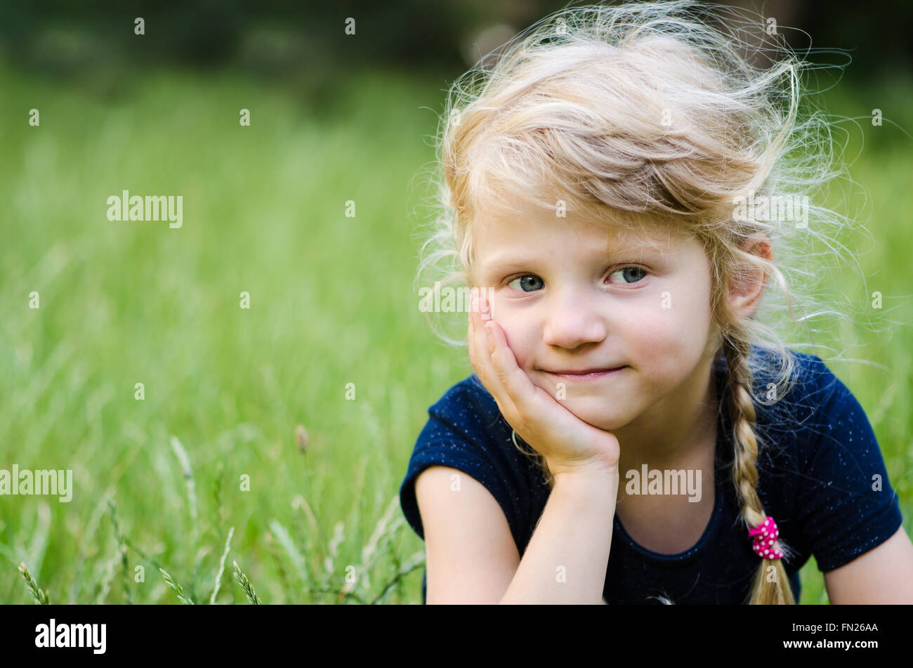 portrait of thoughtful blond girl with braided hair Stock Photo