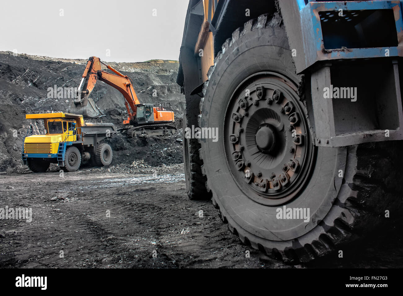 Excavator loading mining truck Stock Photo