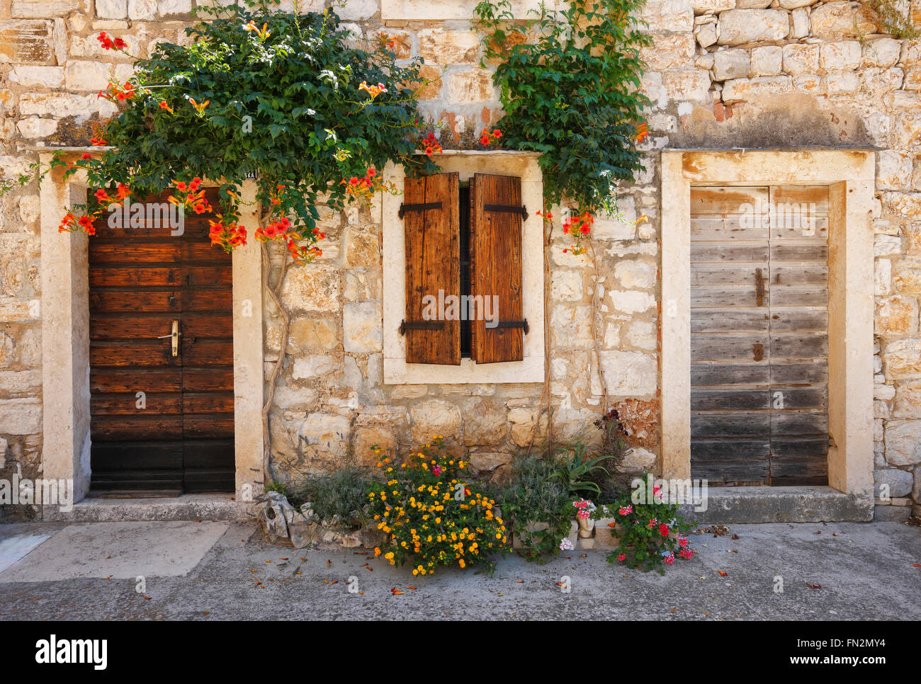 Facade of old traditional stone house with wooden door and window in ...