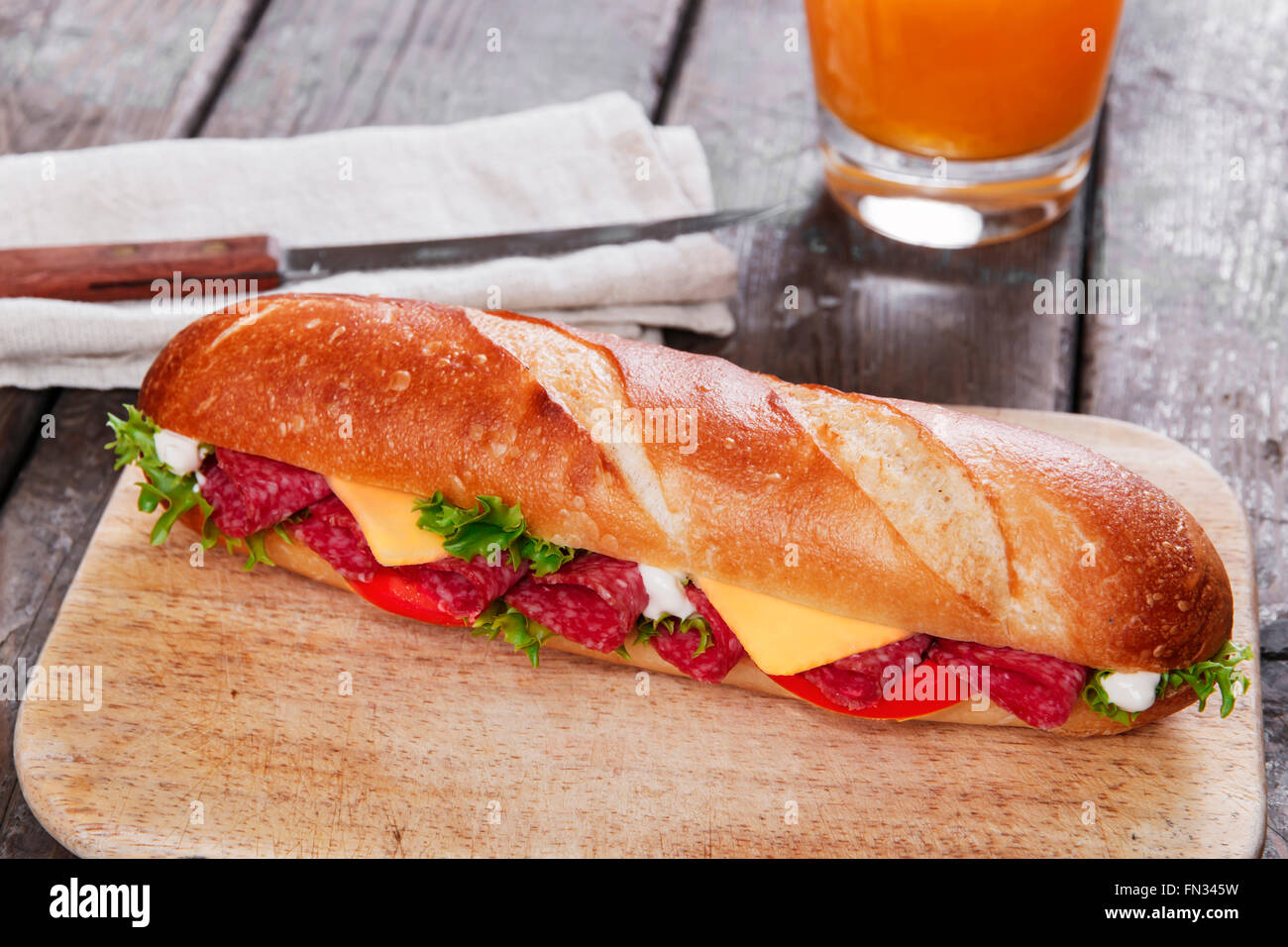 sandwich baguette cheese salami tomato sauce and herbs Stock Photo - Alamy