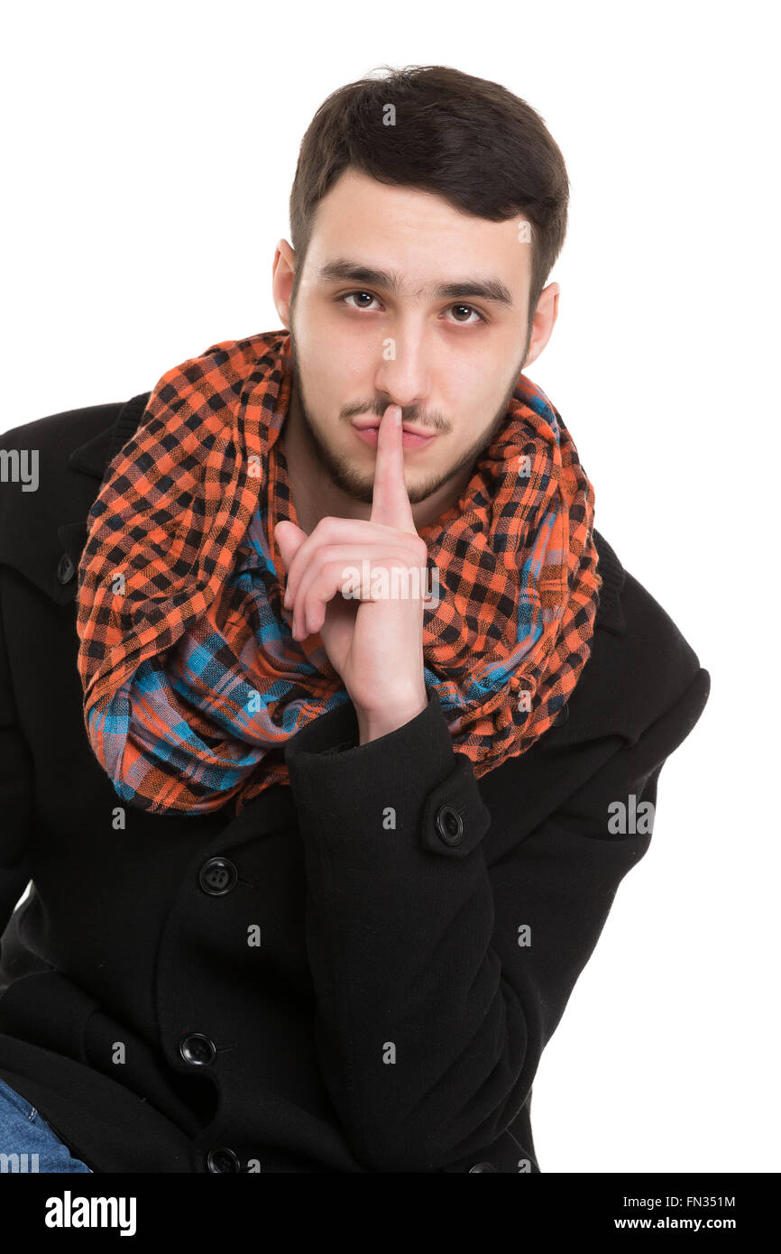 Young Man is Asking for Silence, isolated on white background Stock Photo