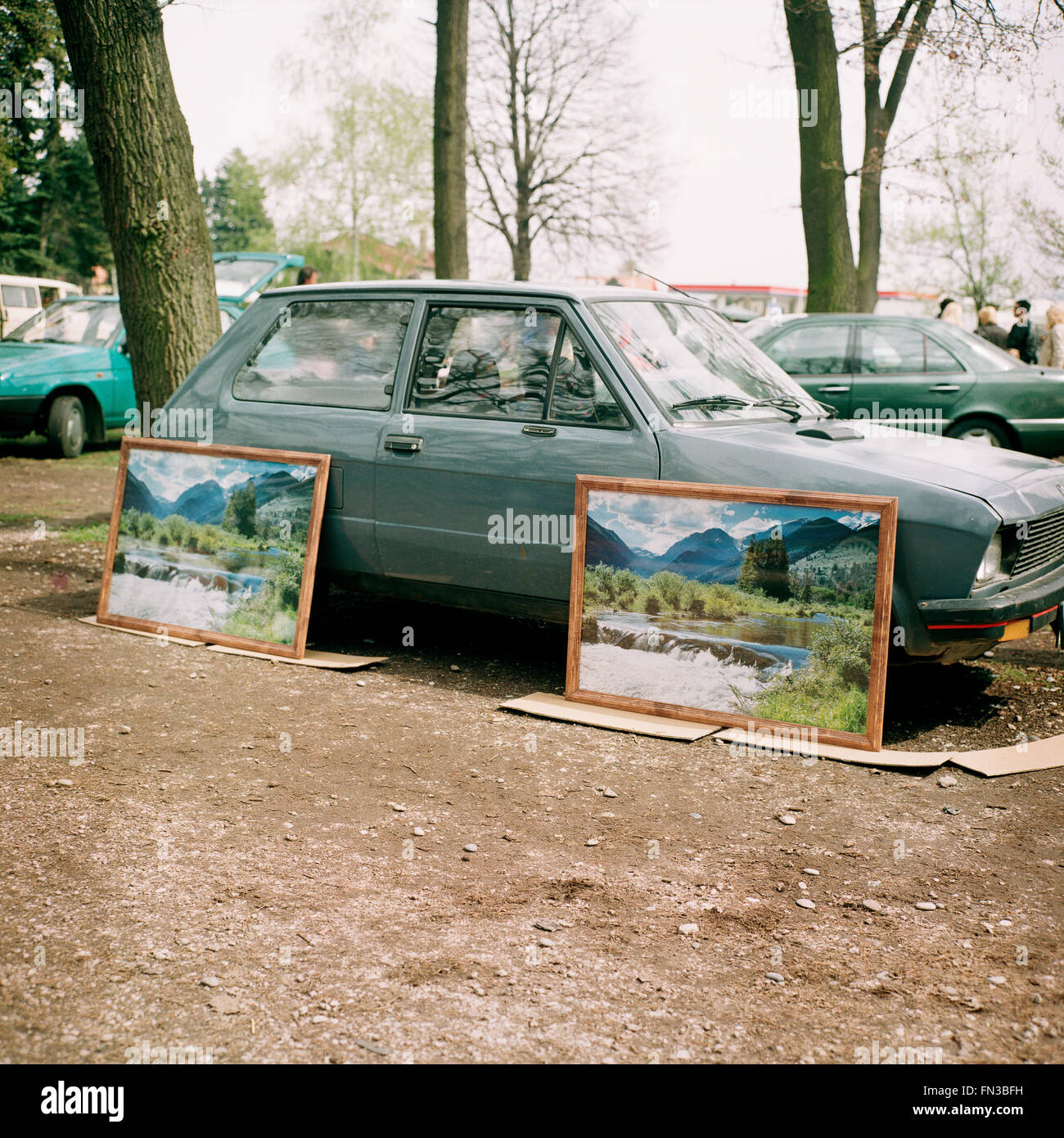 Two identical landscape images  hanging on a Yugo car on a flea market in Maribor, Slovenia. Stock Photo