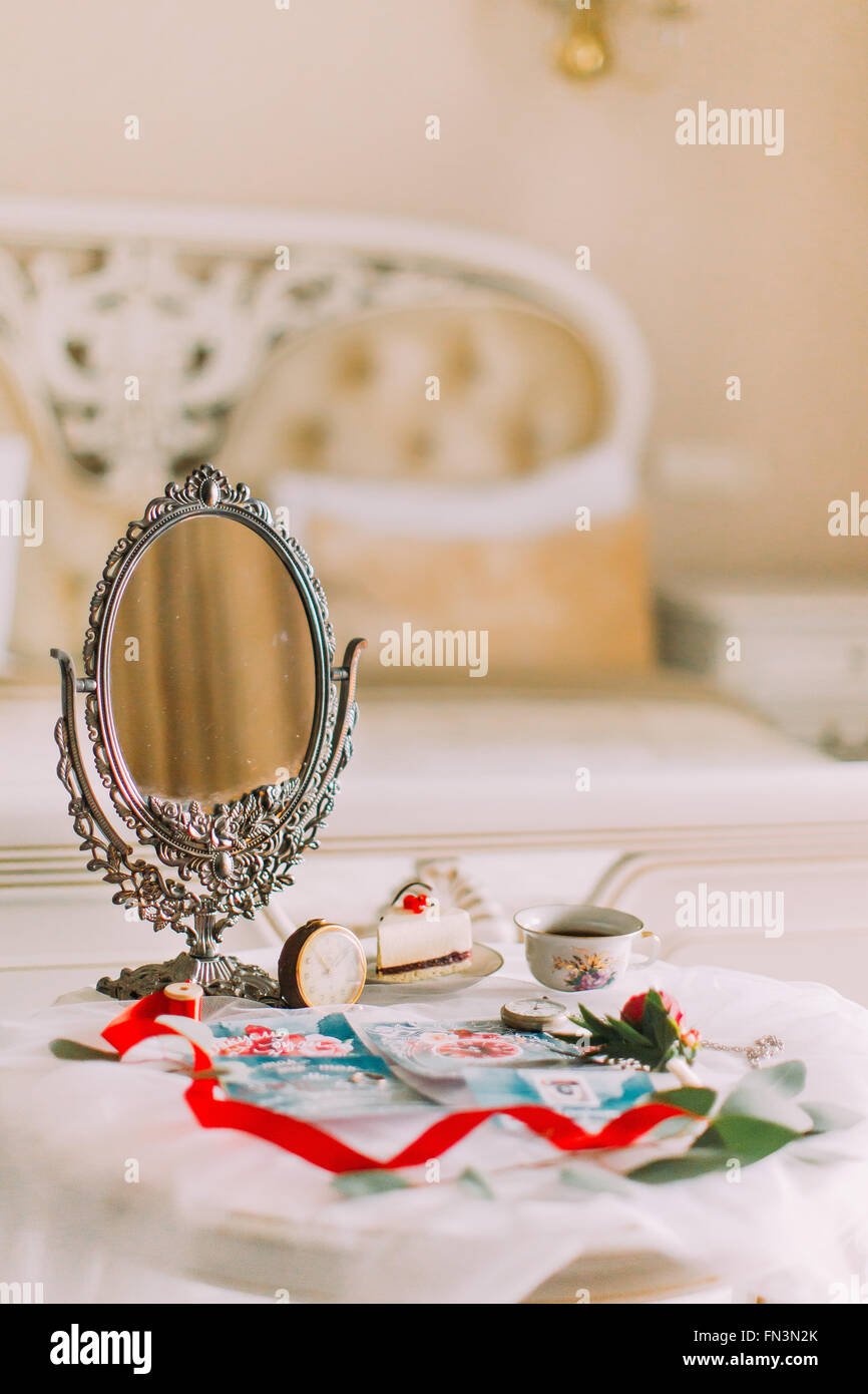 Beautiful white vintage table with mirror in victorian style. Tea time