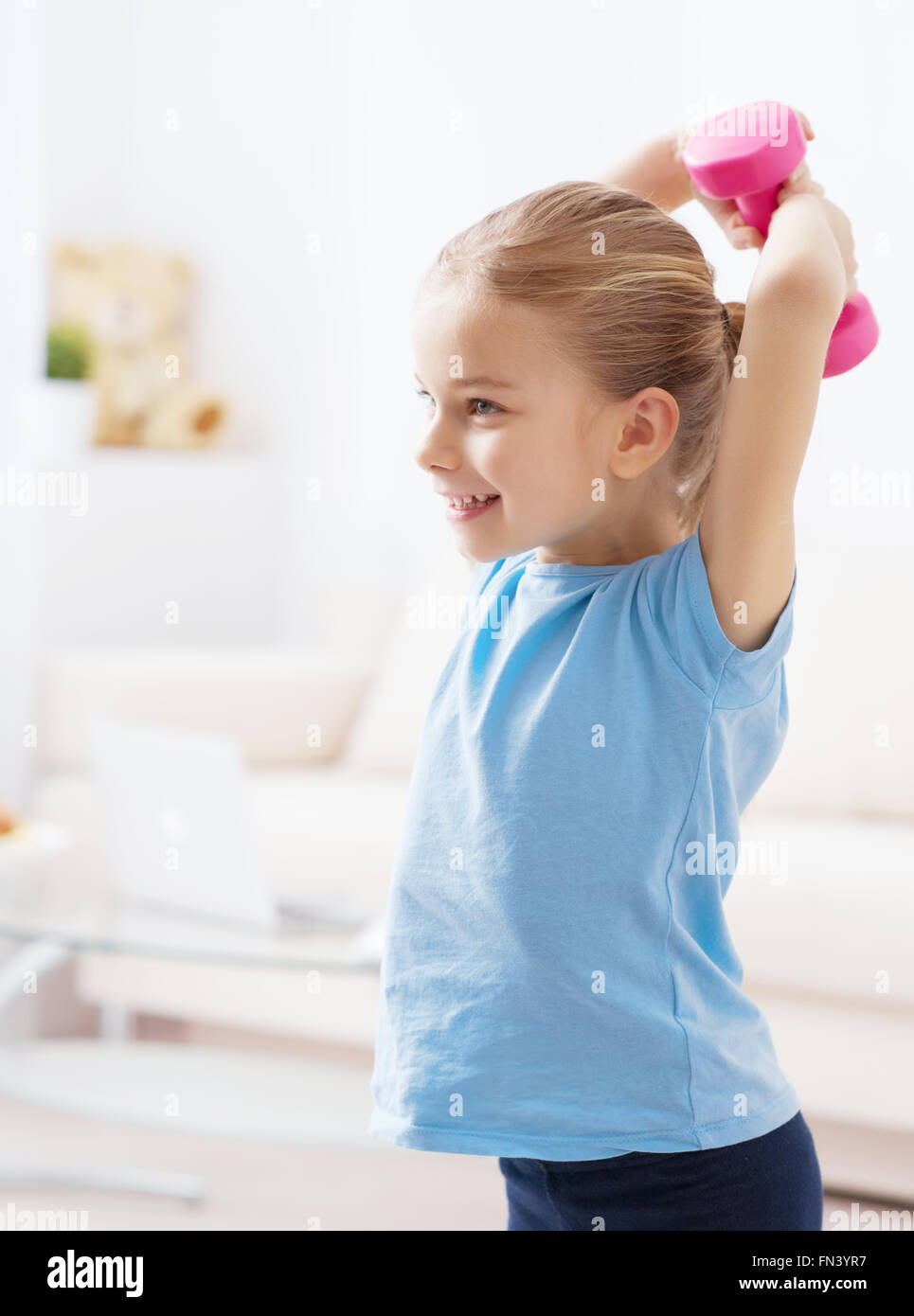 Little girl doing exercises with kettlebell Stock Photo - Alamy