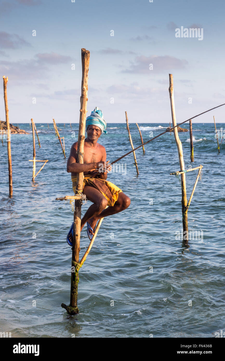 Sri Lankan stilt fishing, Sri Lankan stilt fishermen at sunset Stock