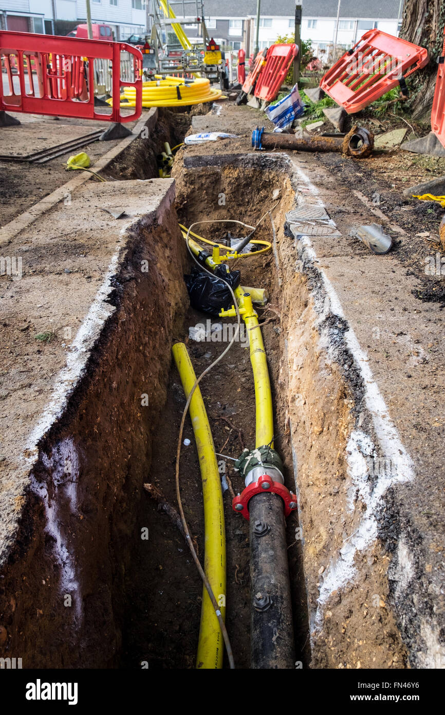 Old metal gas mains pipes being replaced with plastic pipes to prevent gas leaks due to corrosion of the metal pipes Stock Photo