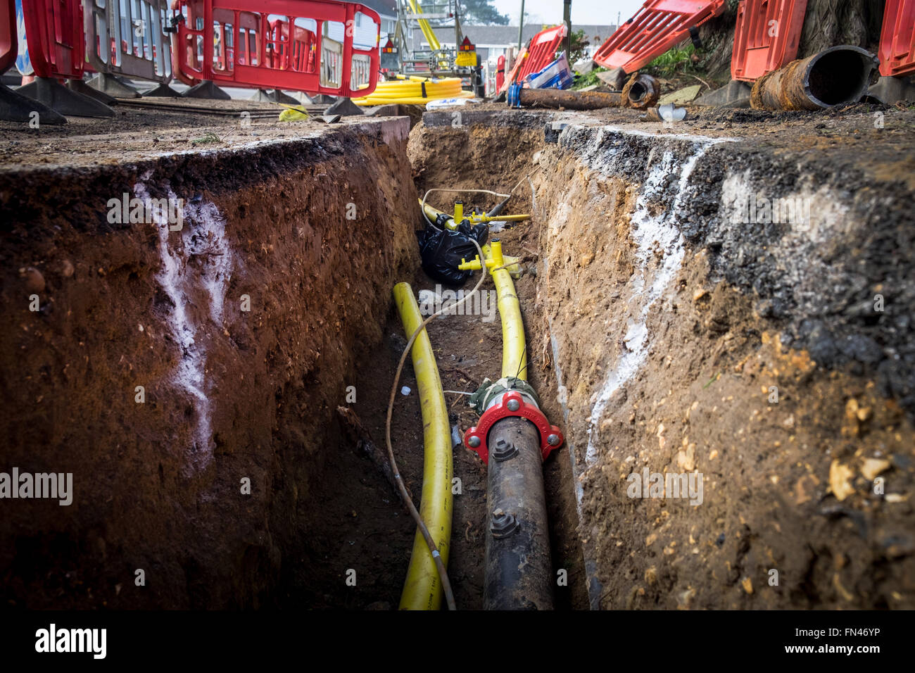 Old metal gas mains pipes being replaced with plastic pipes to prevent gas leaks due to corrosion of the metal pipes Stock Photo