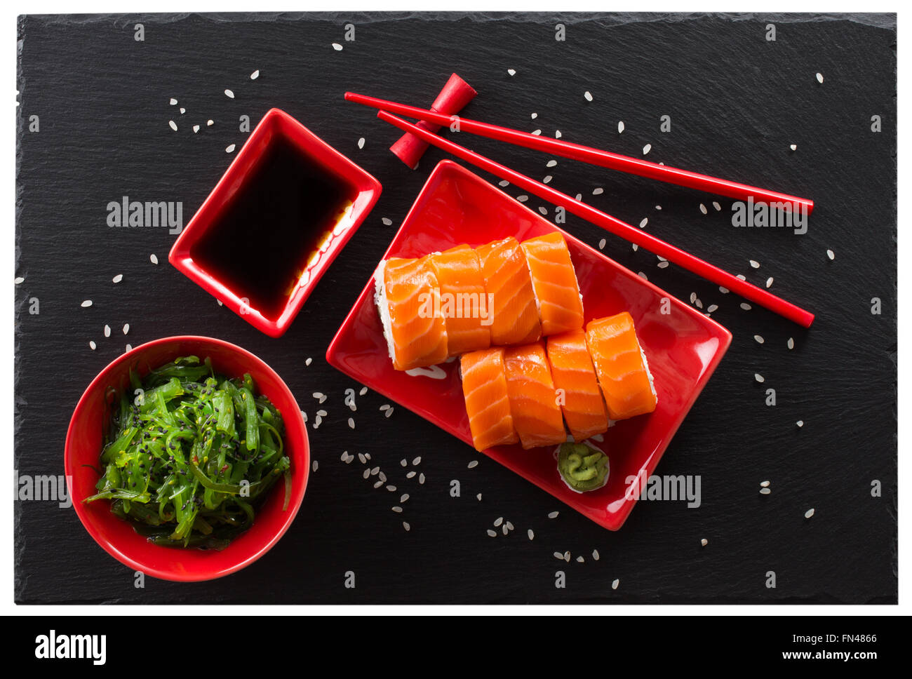 sushi and green seaweed salad on a slate table. Stock Photo