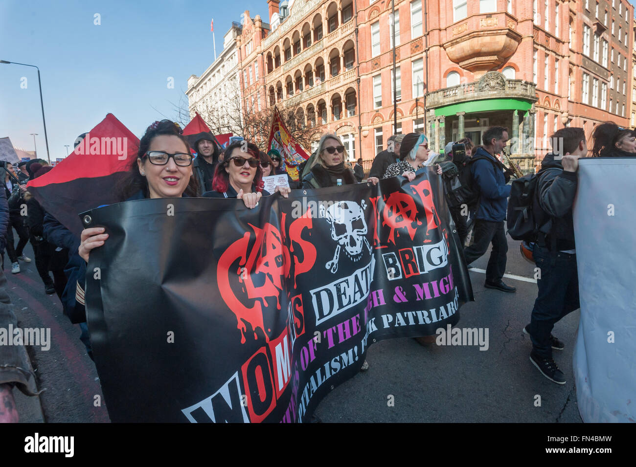 London, UK. 13th March, 2016. Class War and  block traffic at Waterloo during the march against the Housing and Planning Bill.  They oppose the Bill which they say will make the current housing crisis much worse, but are also protesting against Labour London councils who are selling off council estates to private developers in what is called regeneration, resulting in ordinary Londoners being forced out of their homes. Peter Marshall/Alamy Live News Stock Photo