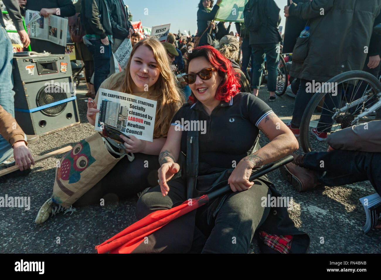 London, UK. 13th March, 2016.  Jasmin Stone of Focus E15 and Lisa Mckenzie of Class War at the sit-down blocking Westminster Bridge in protest against the Housing and Planning Bill. Jasmin holds a poster of the Carpenters Estate, Stratford, socially cleansed by Labour run Newham Council. Peter Marshall/Alamy Live News Stock Photo