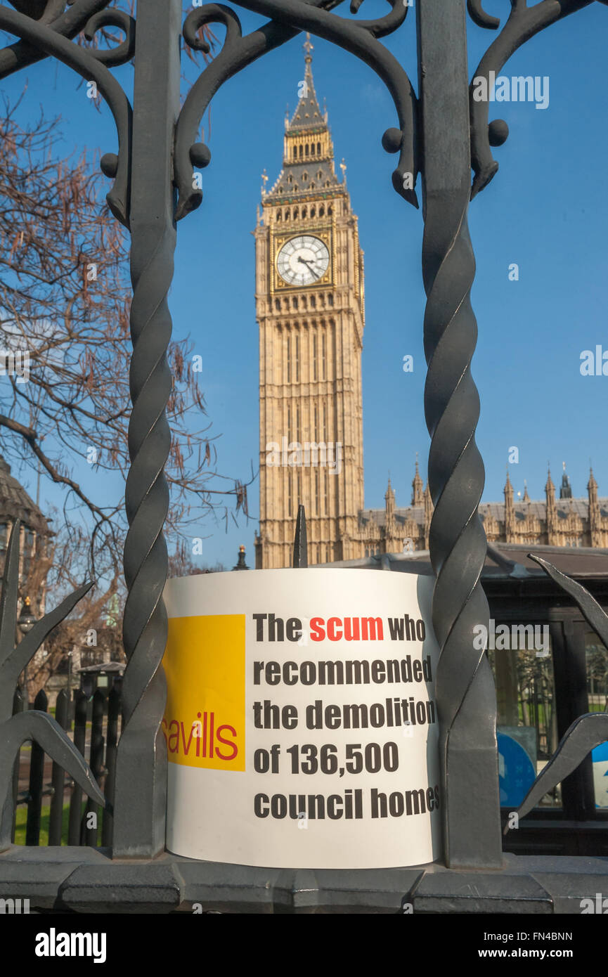 London, UK. 13th March, 2016. Thousands march through London to a rally in Parliament Square against the Housing and Planning Bill which they say will make the current housing crisis much worse. A poster left outside Parliament about estate agents Savills, who the government took advice from, 'The scum who recommended the demolition of 136,500 council homes.' Peter Marshall/Alamy Live News Stock Photo
