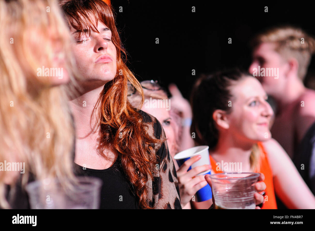 BENICASIM, SPAIN - JULY 19: Redhead woman from the audience applauding at FIB (Festival Internacional de Benicassim) 2013. Stock Photo