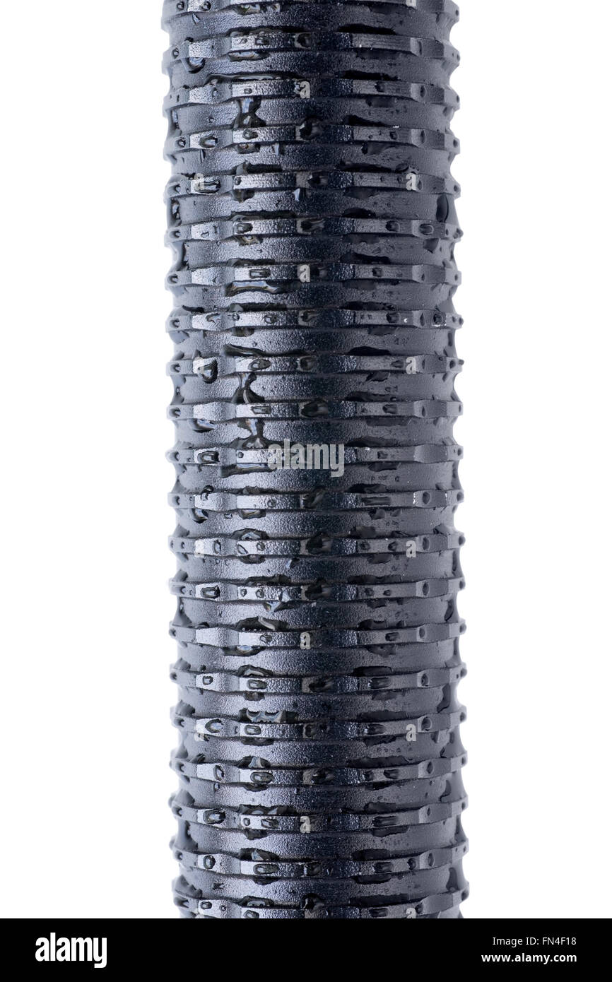 Black steel corrugated length of pipe with water drops. Isolated on white with clipping path Stock Photo