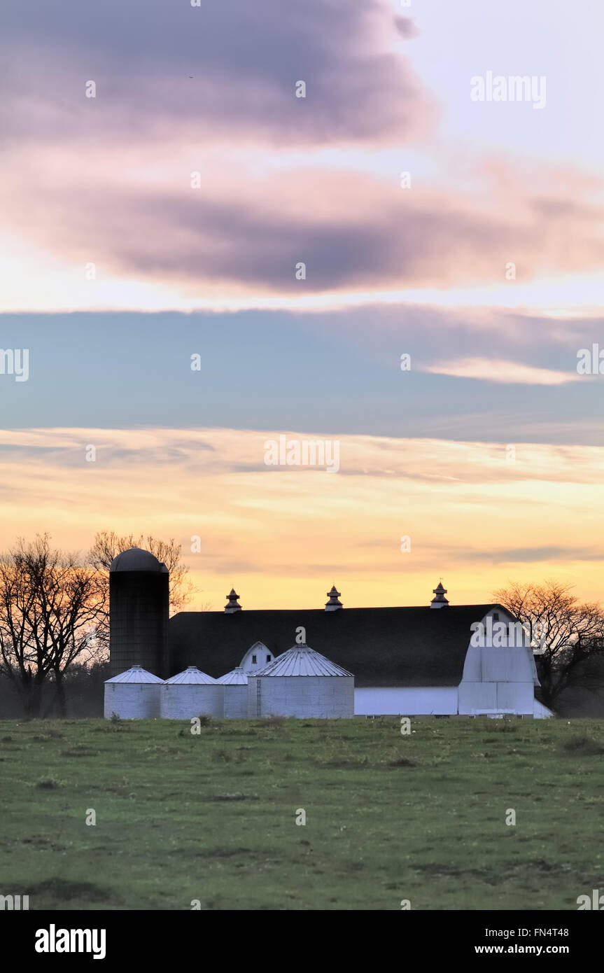 Day comes to a colorful end above a modern dairy farm in South Elgin