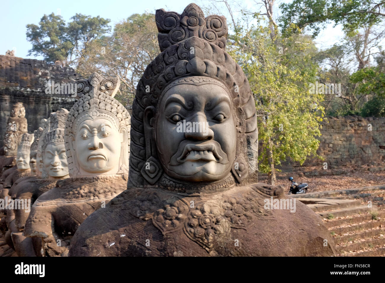 Statues with interesting faces line the entrance to Angkor Thom Temple Complex near Siem Reap, Cambodia Stock Photo