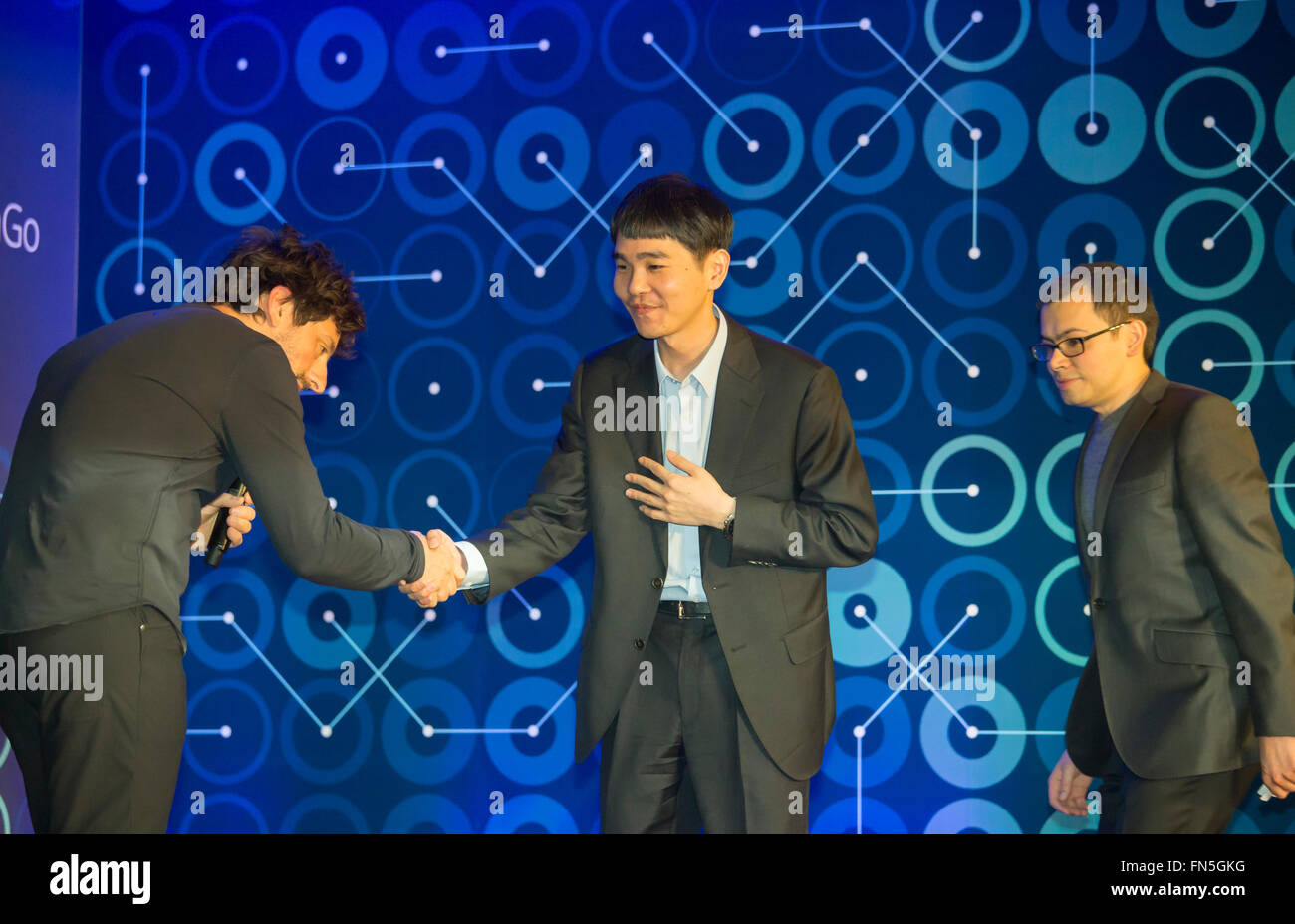 Lee Se-dol, Demis Hassabis and Sergey Brin, Mar 12, 2016 : South Korean Go master Lee Se-dol (C), Demis Hassabis (R), CEO of the AlphaGo developer Google DeepMind and Sergey Brin, Google co-founder attend a press conference after the third match of the Google DeepMind Challenge Match in Seoul, South Korea. Lee beat on Sunday AlphaGo, the artificial intelligence (AI) program made by Google's DeepMind, for the first time at the fourth match during the special human-versus-computer Go tournament and the five-round Go tournament is now 3-1 as of March 14, 2016, local media reported. (Photo by Lee Stock Photo