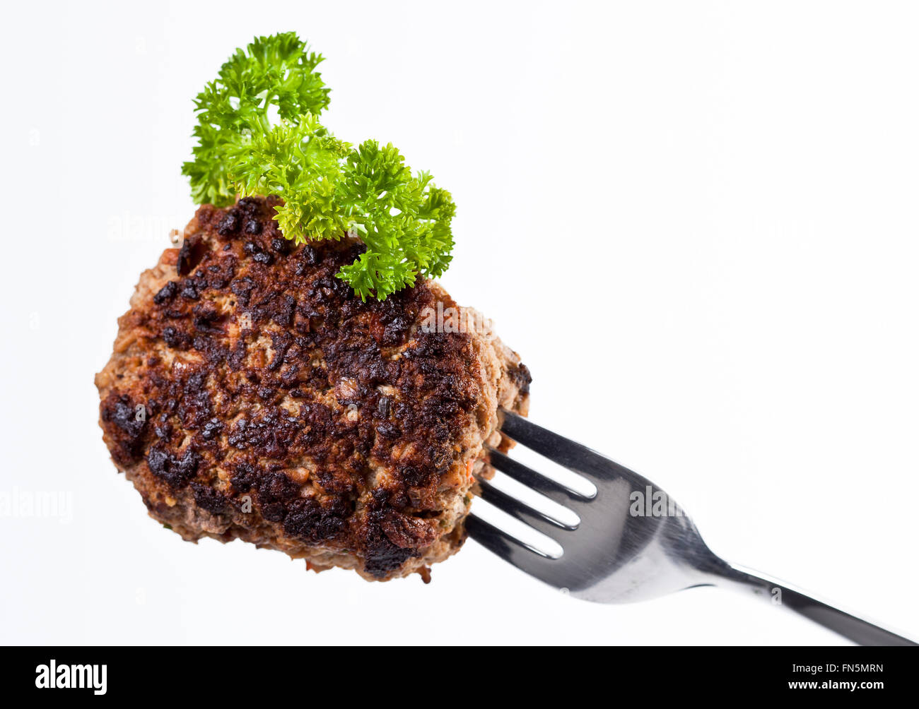 The picture shows a meatball on a fork Stock Photo