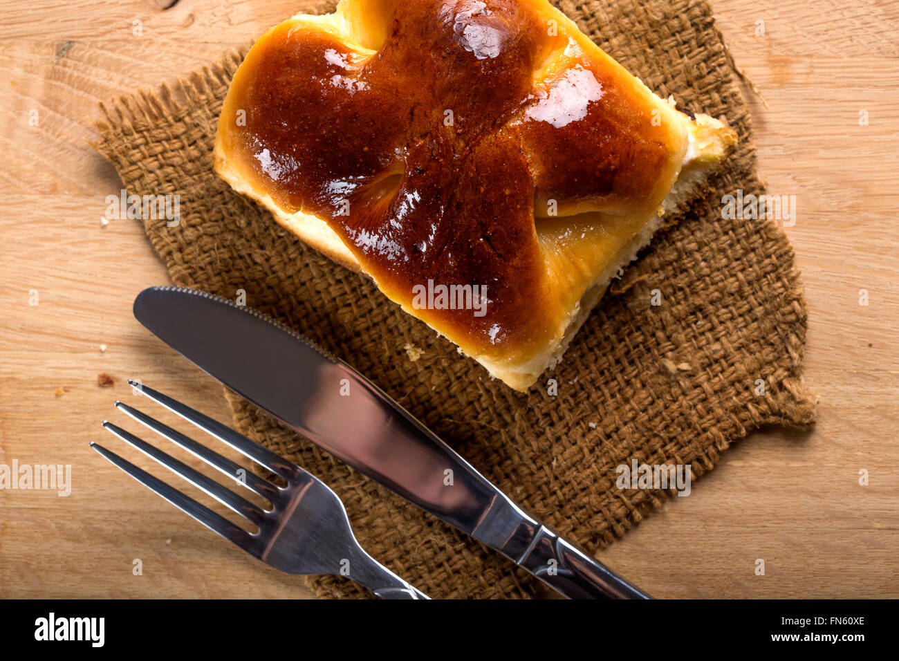 Fresh Romanian cheese pie with fork and knife Stock Photo