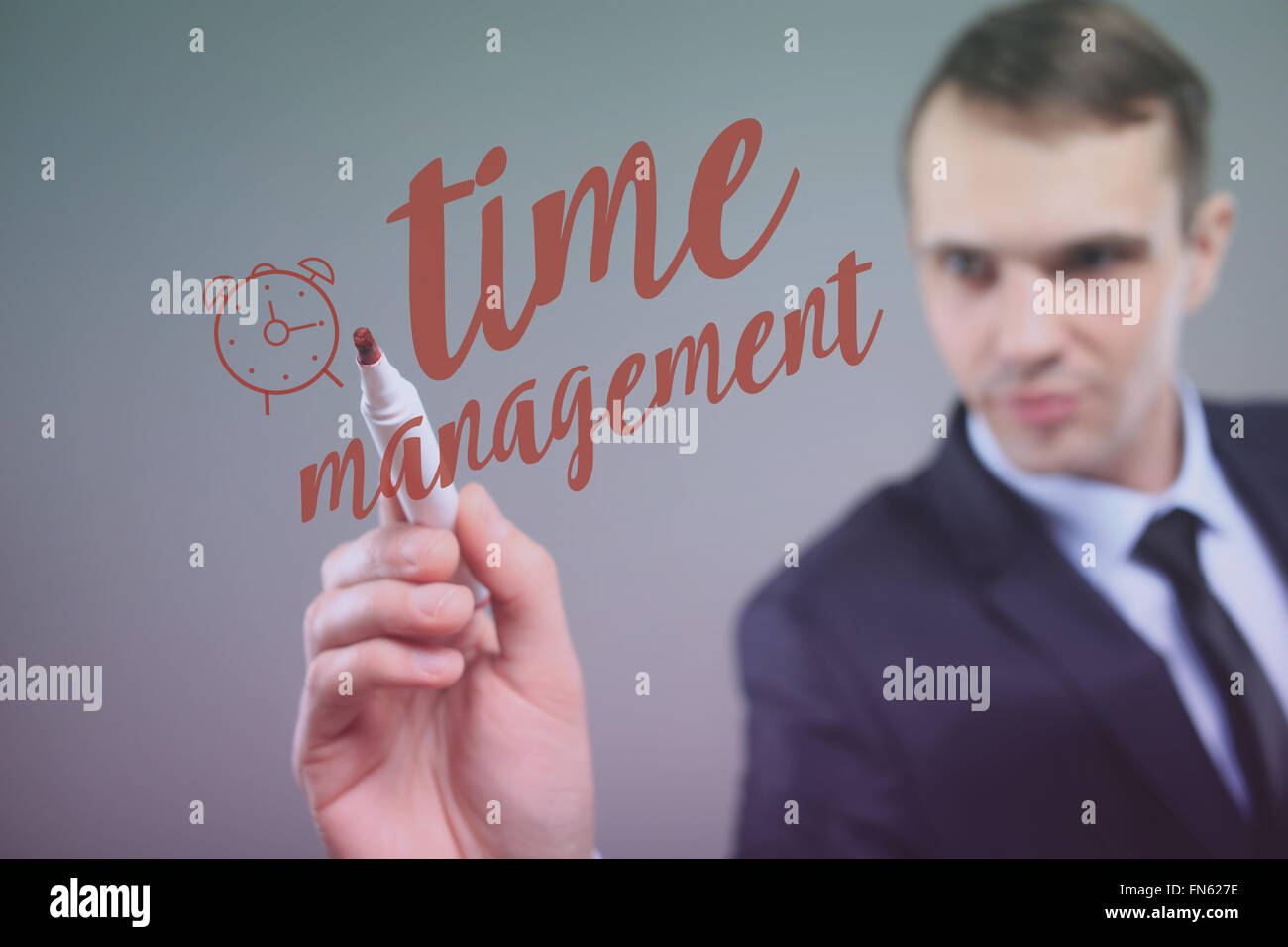 businessman drawing time management on a transparent board Stock Photo