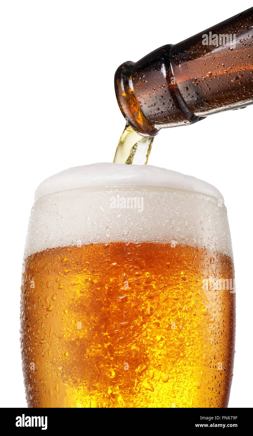 The process of pouring beer into the glass. File contains clipping paths. Stock Photo