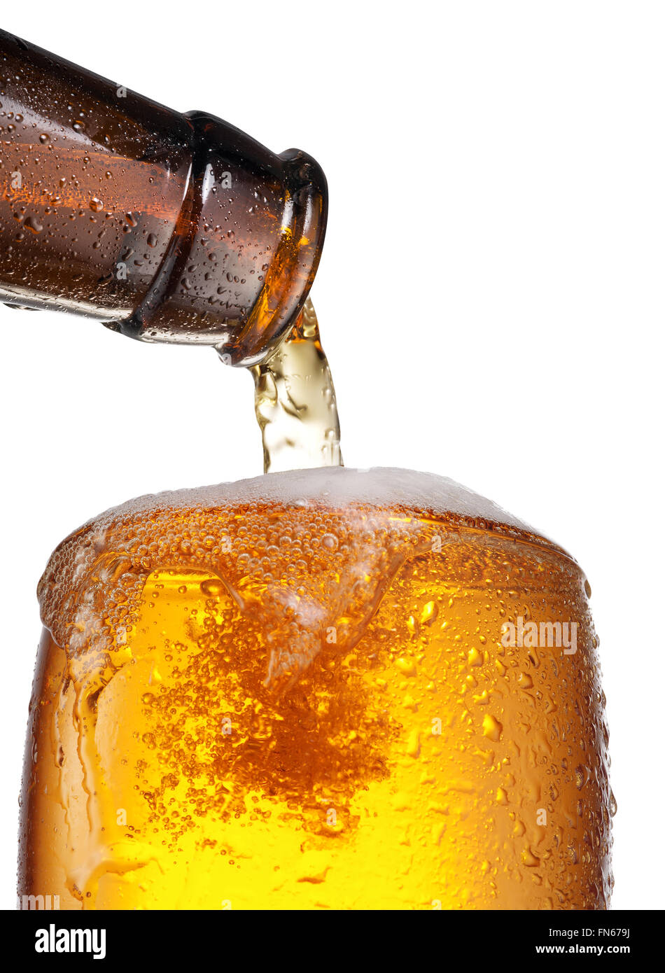 The process of pouring beer into the glass. File contains clipping paths. Stock Photo