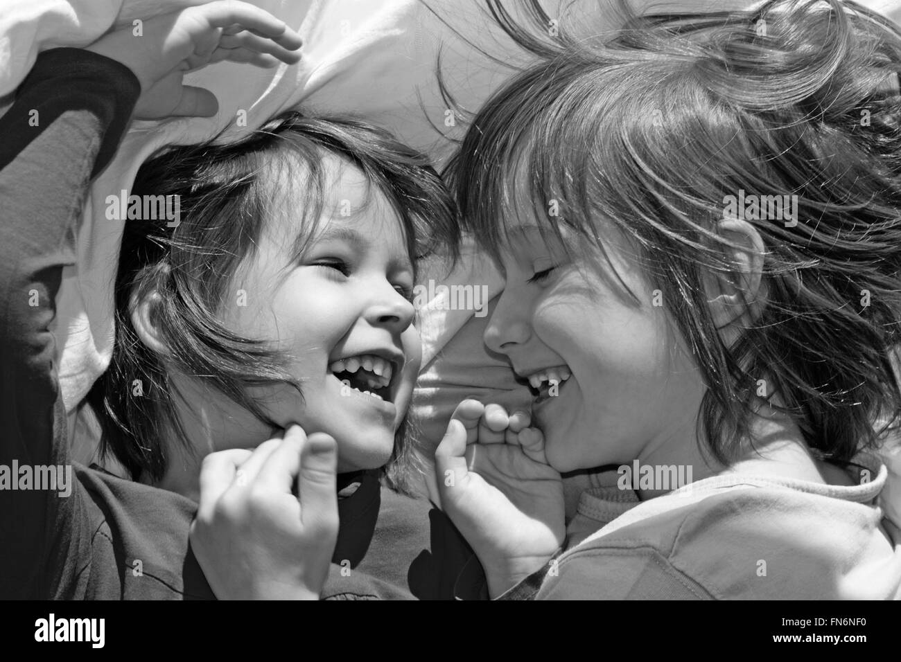 The fun of little sisters in the bed. Stock Photo