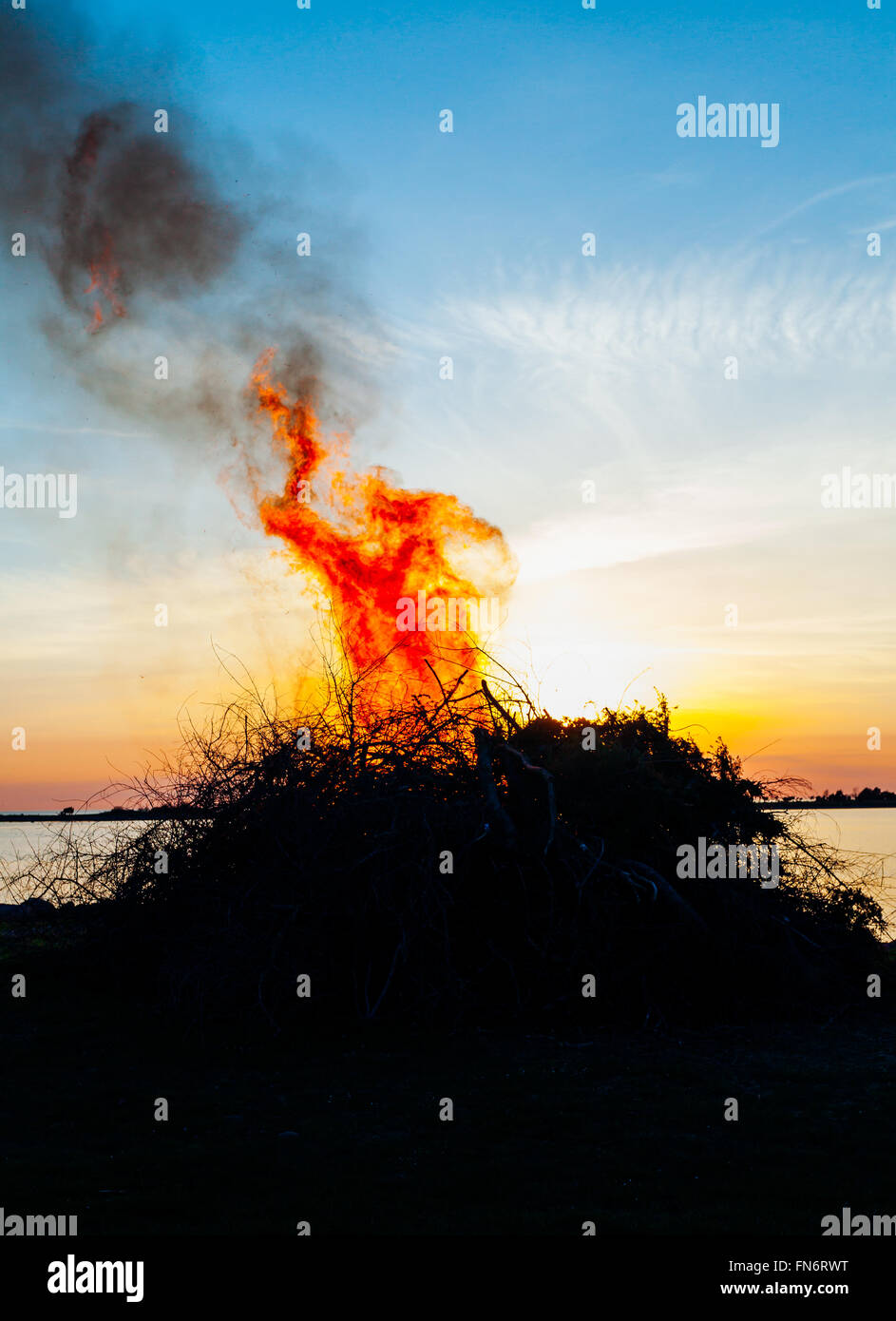 celebrating Walpurgisnight in Sweden bonfire by the sea Stock Photo