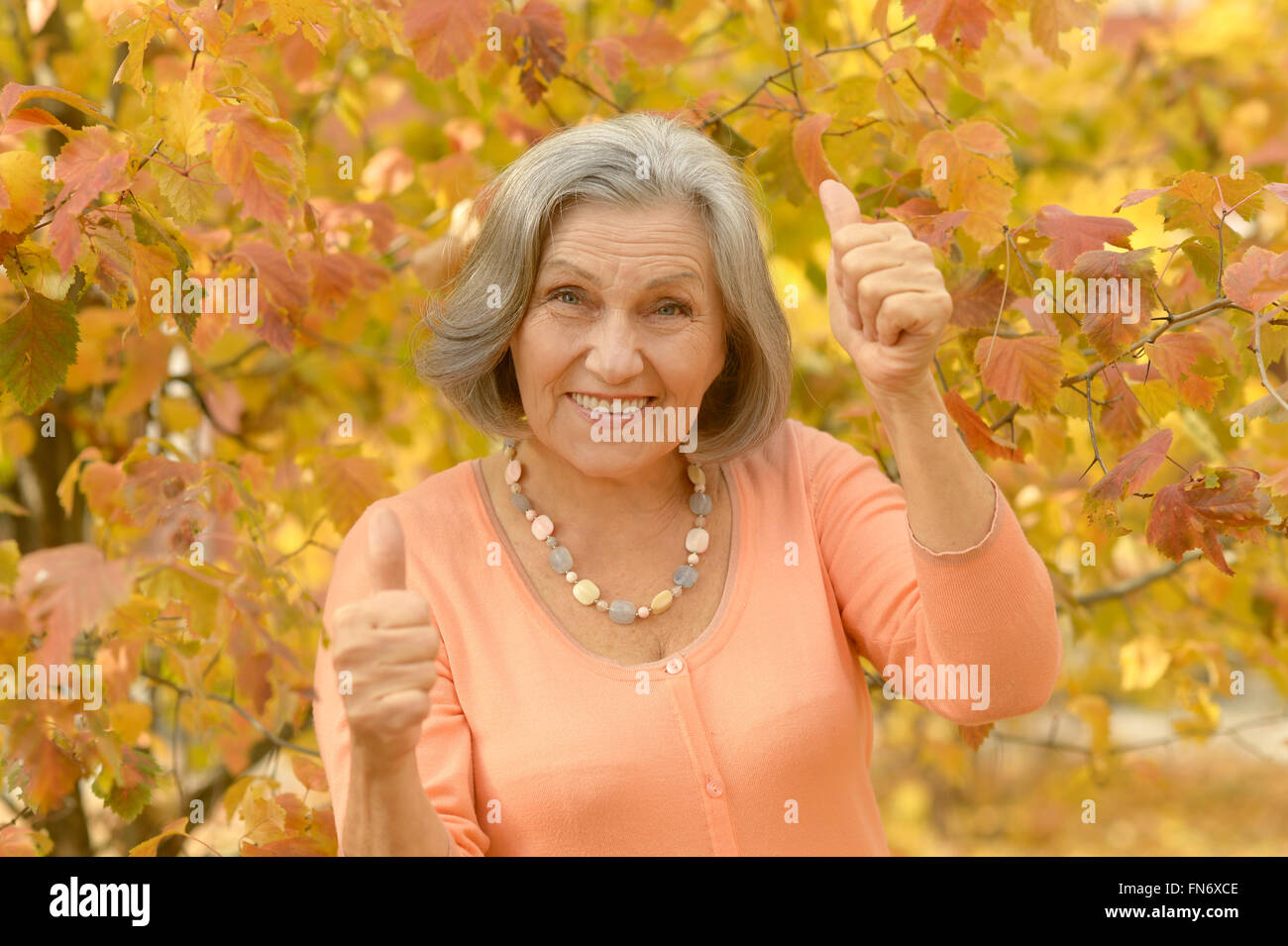 senior woman with thumbs up Stock Photo - Alamy