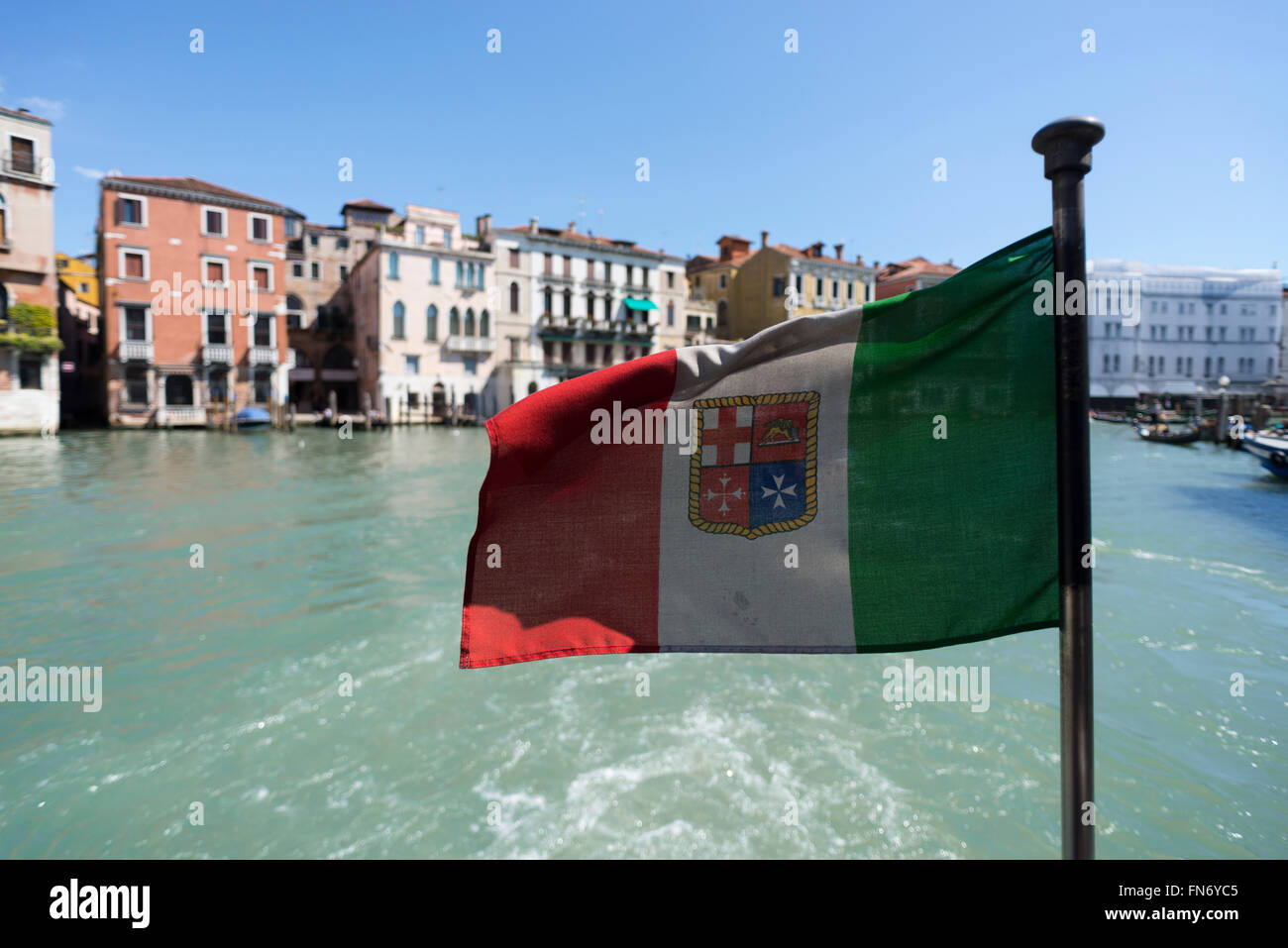 Flag of Venice at the stern of a vaporetto ferry boat in the Canale Grande Stock Photo
