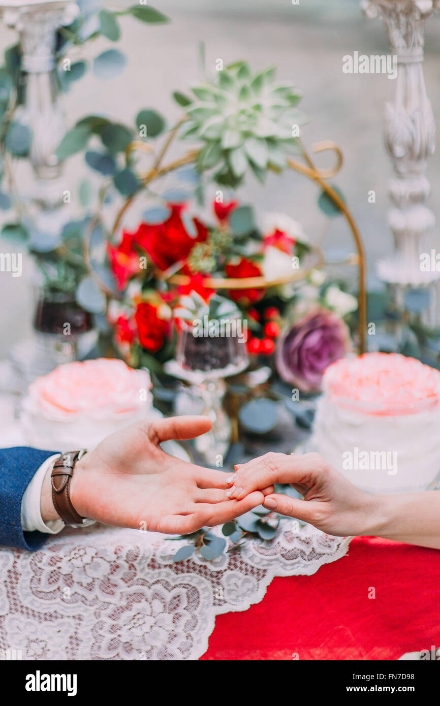 Happy wedding couple softly holding hands close up Stock Photo - Alamy
