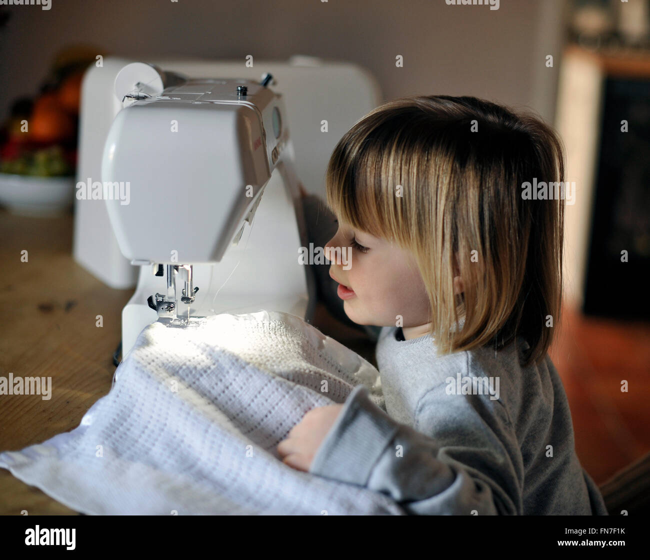 child with sewing machine Stock Photo