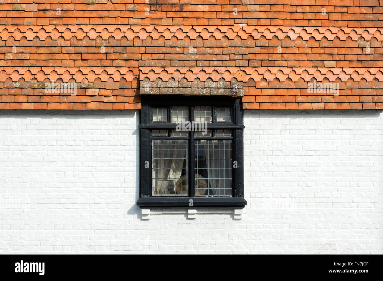 Wall tiles leaded window detail on a house in Dorchester on Thames, Oxfordshire, England Stock Photo