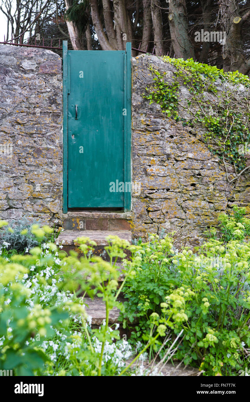 An Old Green Door Set In A Garden Wall Hiding What Is