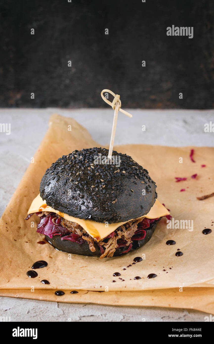 Black burger with stews Stock Photo Alamy