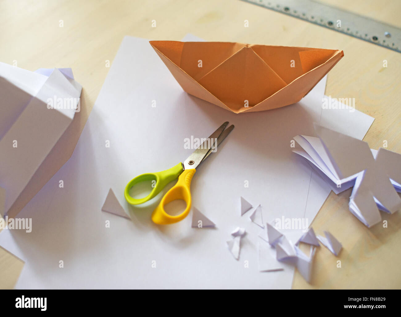 White paper sheet, scissors and origami on the table Stock Photo Alamy