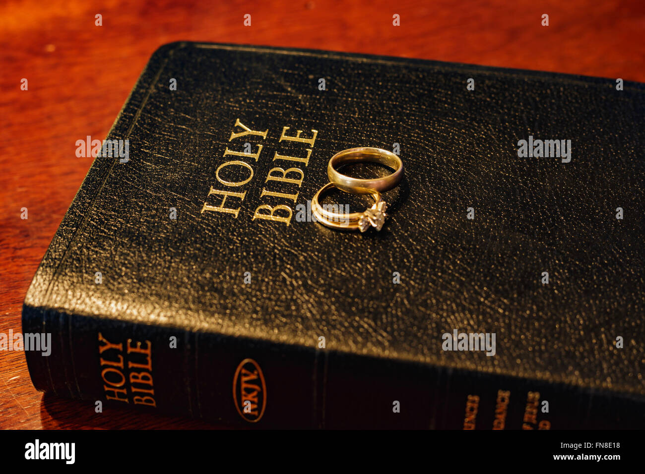 wedding rings on a bible Stock Photo Alamy