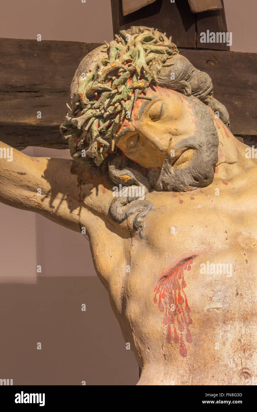 BANSKA STIAVNICA, SLOVAKIA - FEBRUARY, 2015: The detail of carved statue of Christ on the cross as the part of baroque Calvary Stock Photo