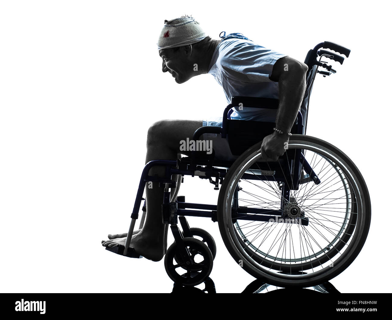 one funny careless injured man in wheelchair in silhouette studio on white background Stock Photo