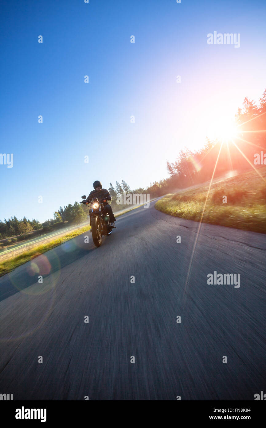 Motorcyclist riding chopper on a road Stock Photo - Alamy