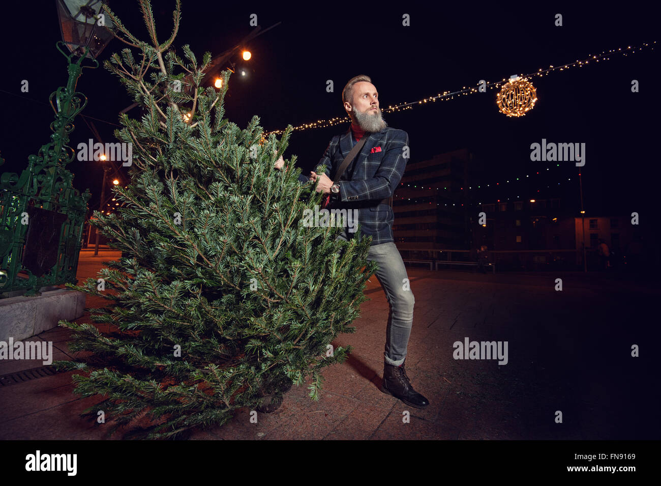 Hipster Man Holding A Christmas Tree Hipster Man Holding A Christmas Tree