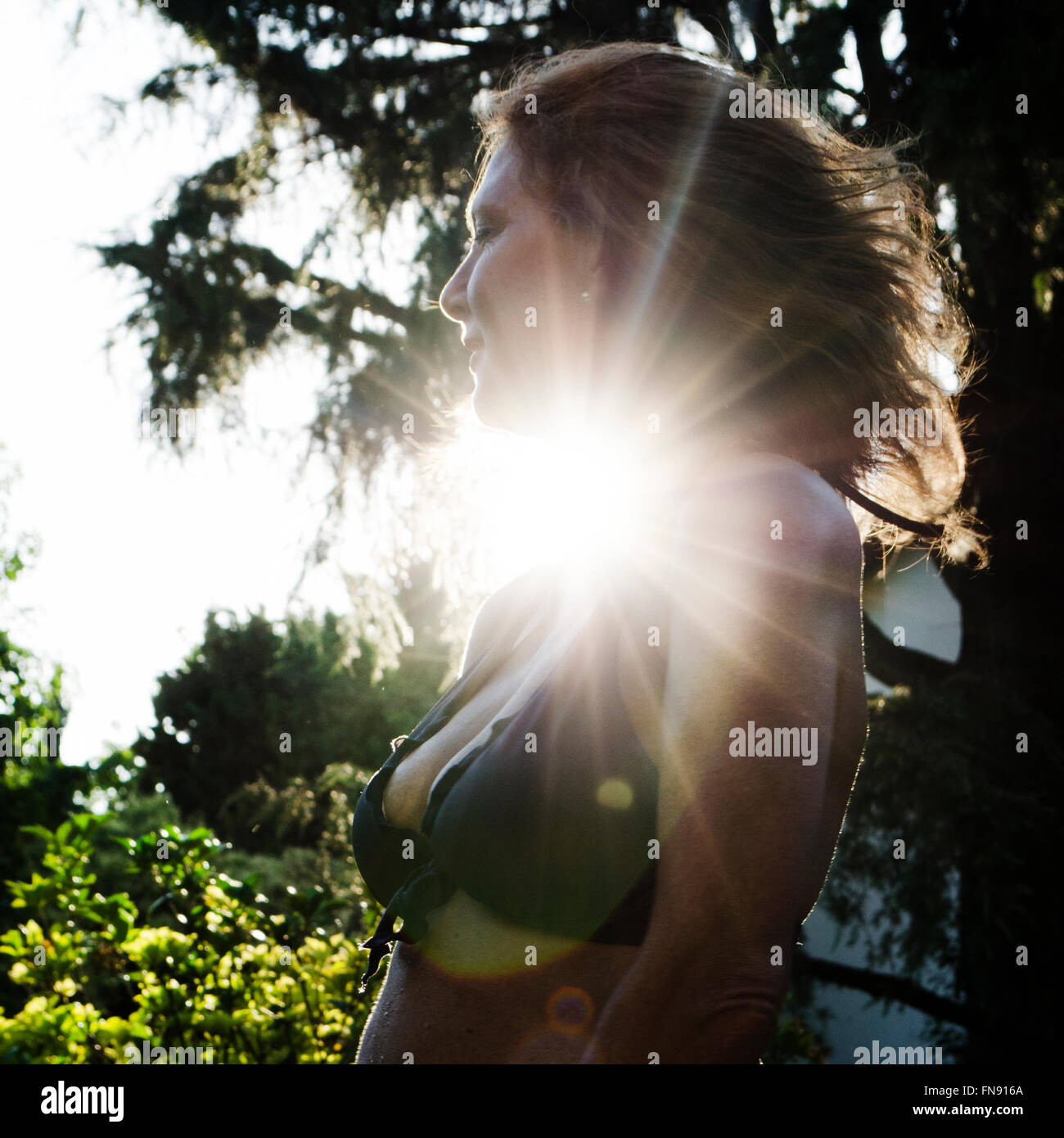 Side view of a woman in sunlight Stock Photo