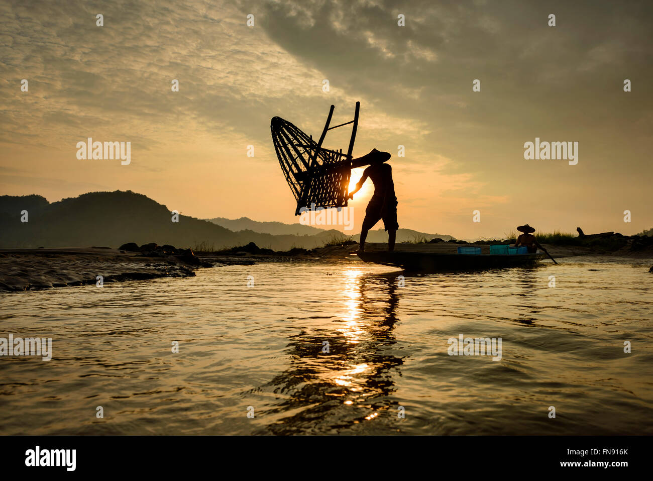 Two fishermen fishing on Mekong River, Laos Stock Photo